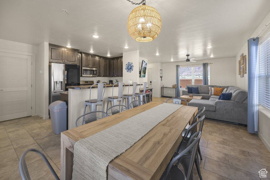 Dining area with a chandelier, ceiling fan, and recessed lighting