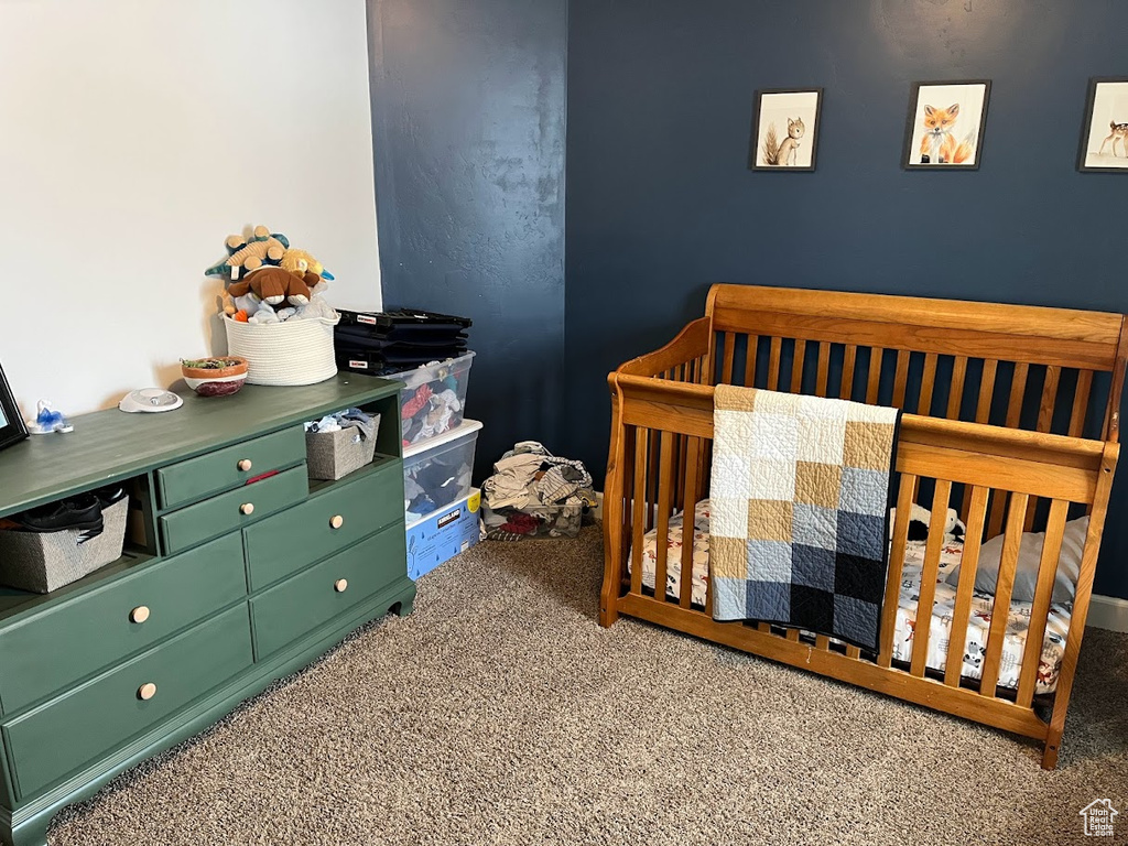 Carpeted bedroom with a nursery area