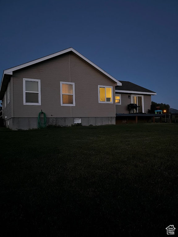 View of side of home featuring a lawn
