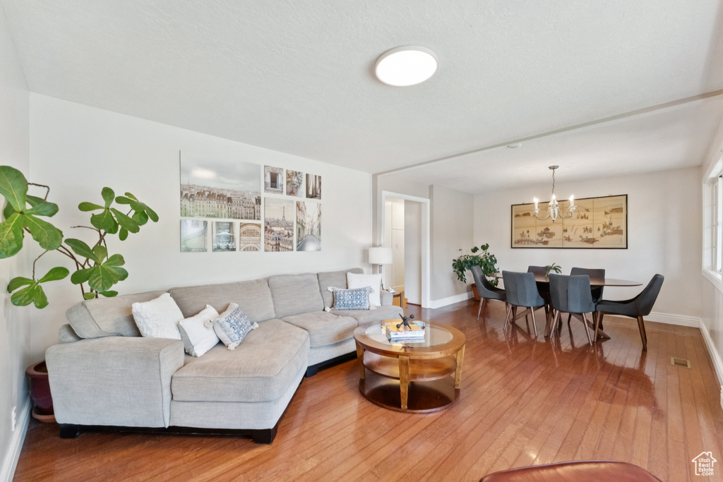 Living room featuring hardwood / wood-style flooring and a chandelier