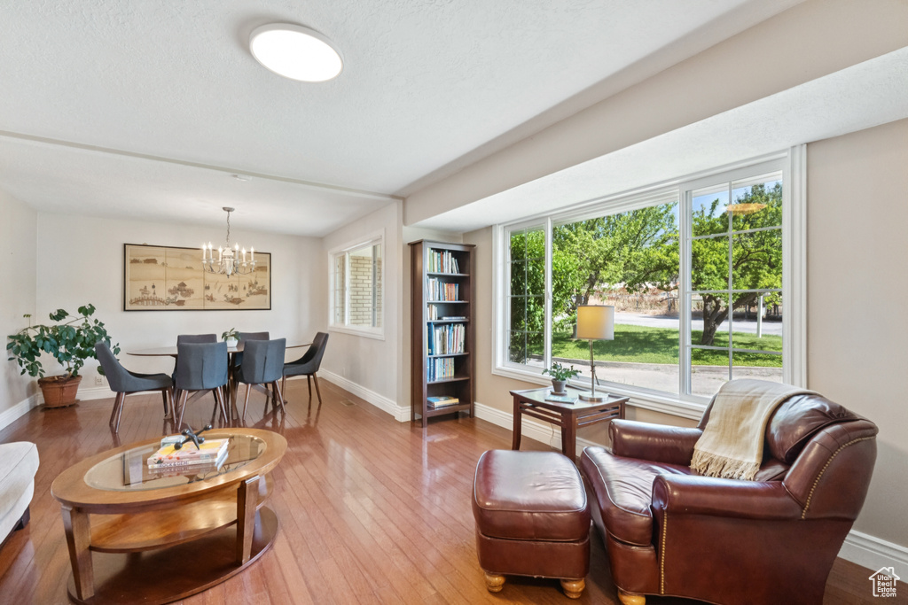 Living room featuring a chandelier and wood-type flooring