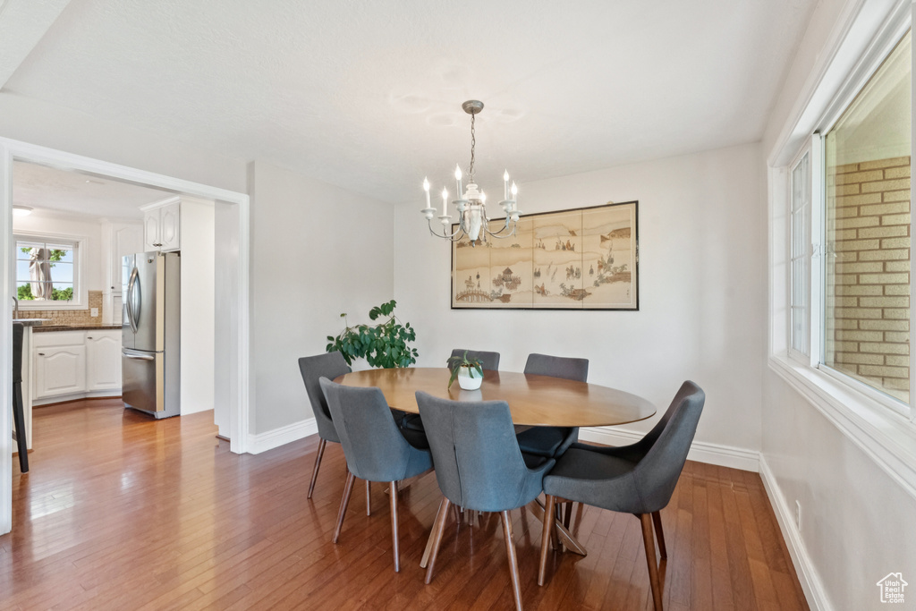 Dining space featuring a chandelier and hardwood / wood-style flooring