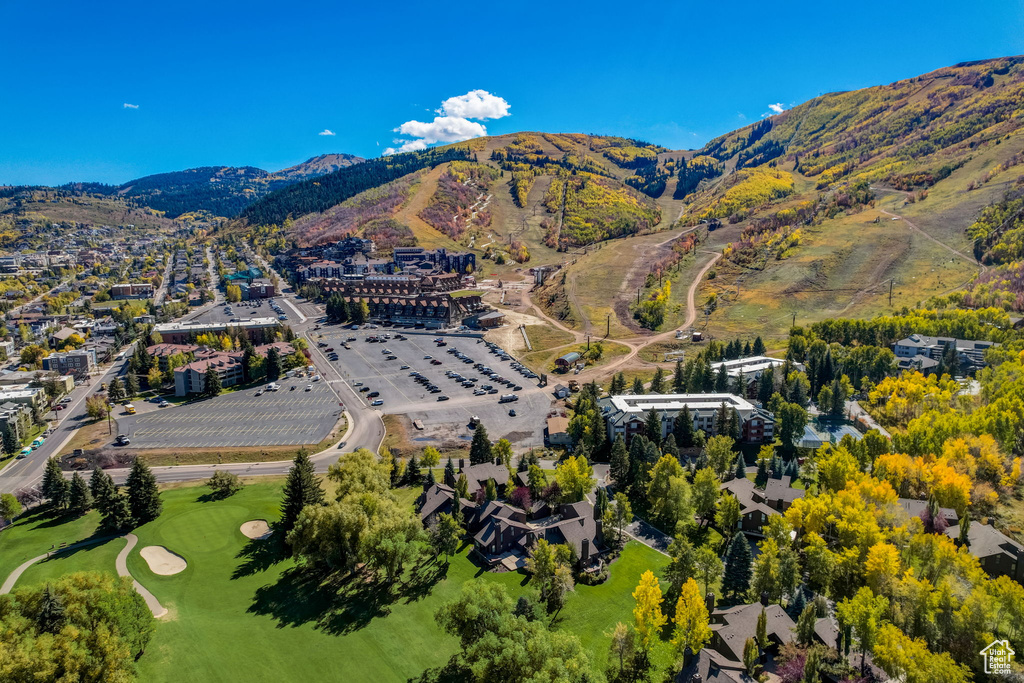 Aerial view of property and surrounding area featuring a mountain backdrop