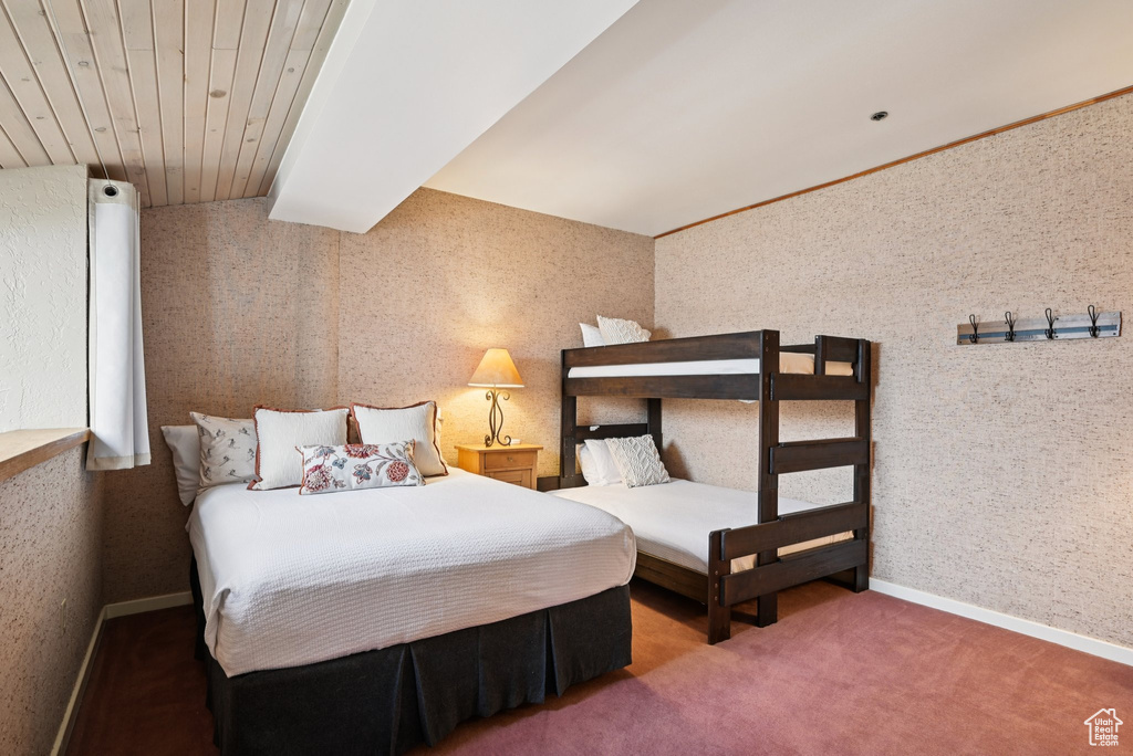 Bedroom featuring wallpapered walls and carpet flooring