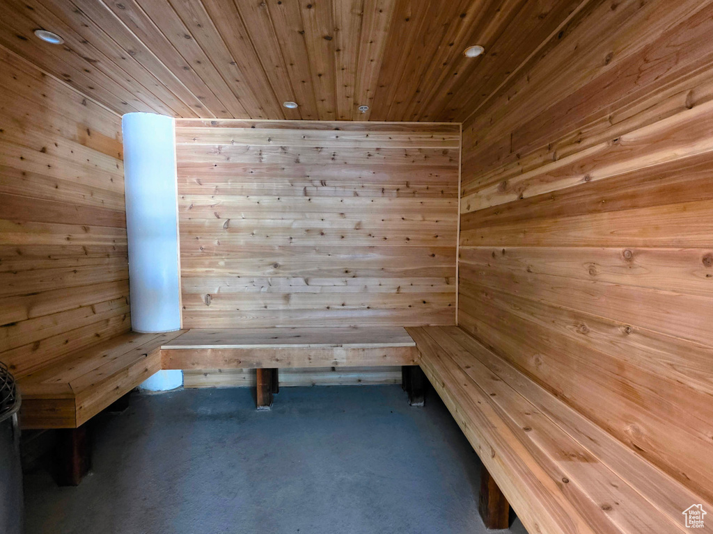 Sauna / steam room with wooden ceiling, wooden walls, carpet floors, and recessed lighting