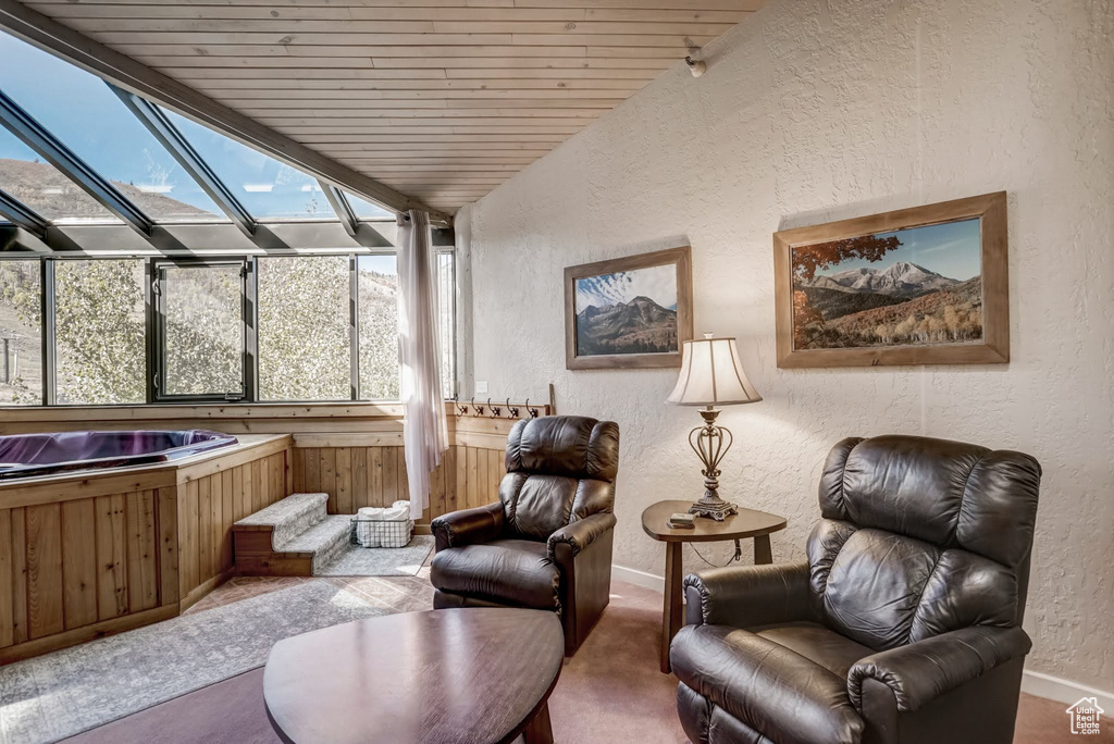 Sunroom featuring a jacuzzi, plenty of natural light, and vaulted ceiling