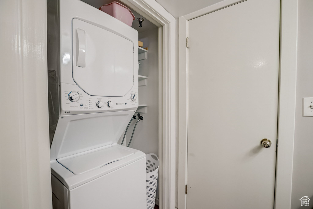 Washroom with stacked washer and clothes dryer
