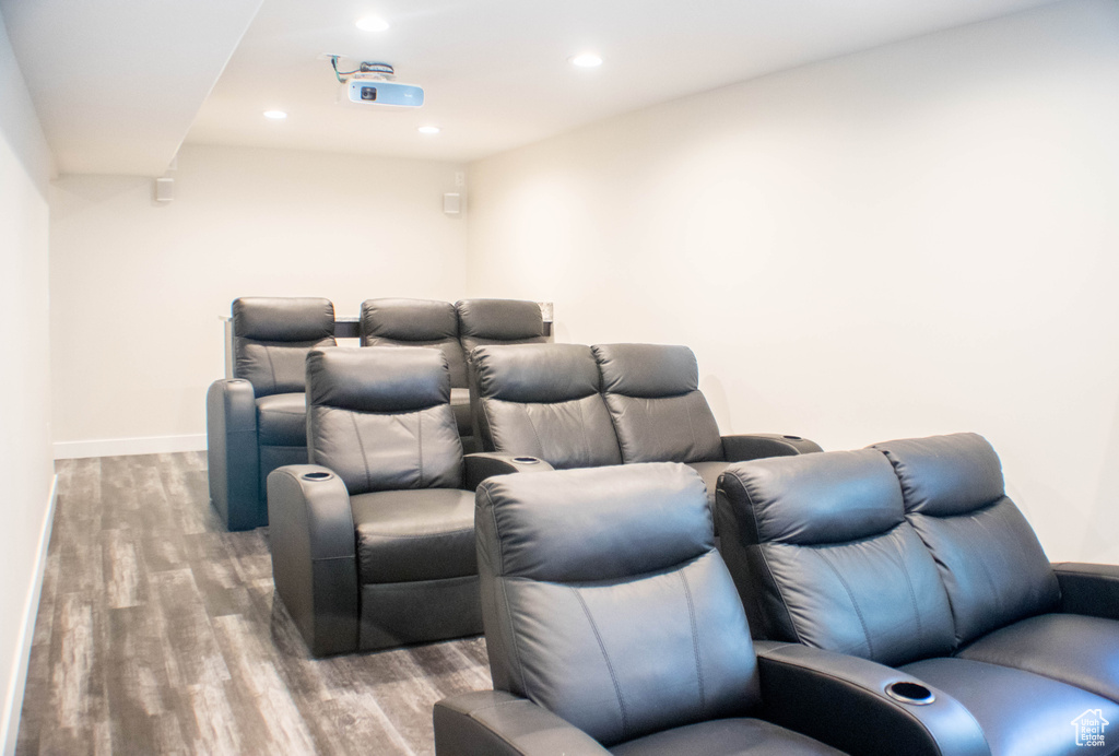 Home theater room featuring wood finished floors and recessed lighting