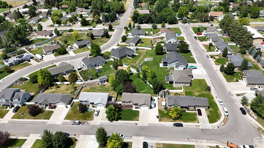 Aerial view of property and surrounding area featuring nearby suburban area