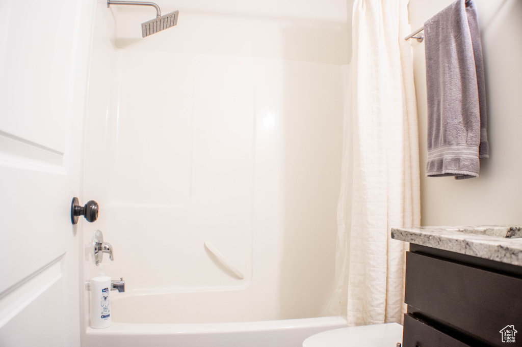Full bath with shower / bath combination with curtain and vanity