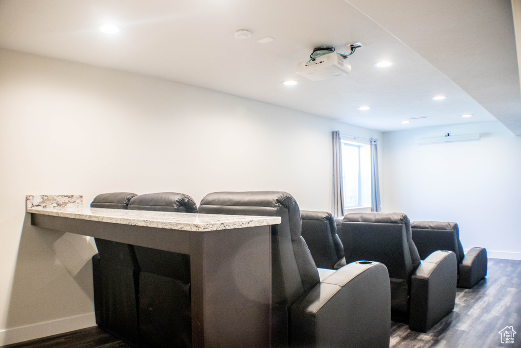 Cinema featuring dark wood-type flooring and recessed lighting