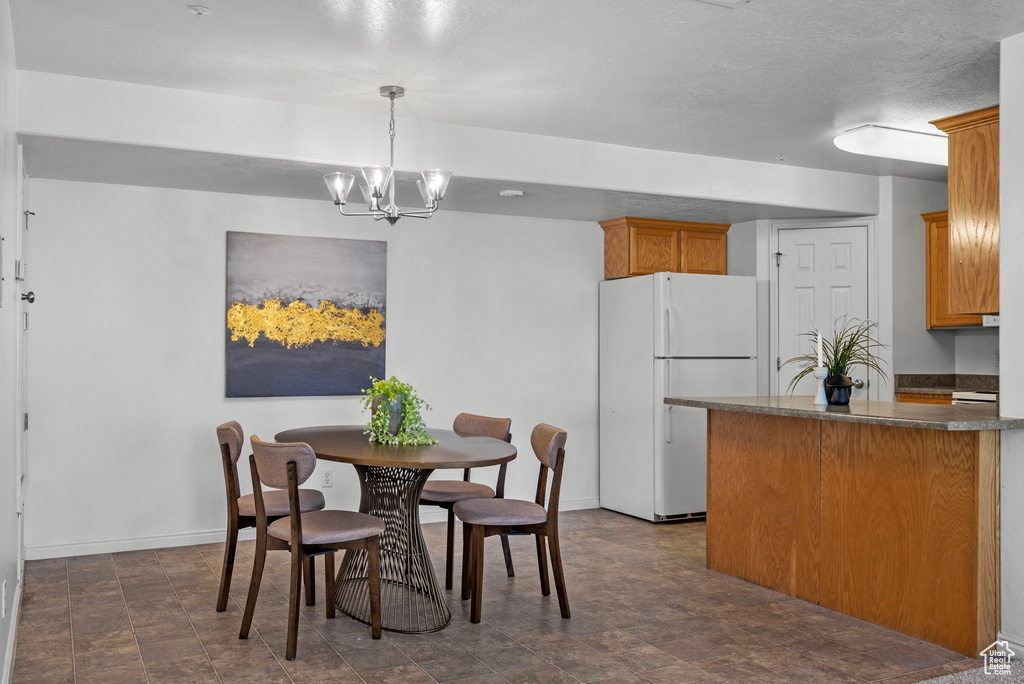 Dining room with baseboards and a chandelier