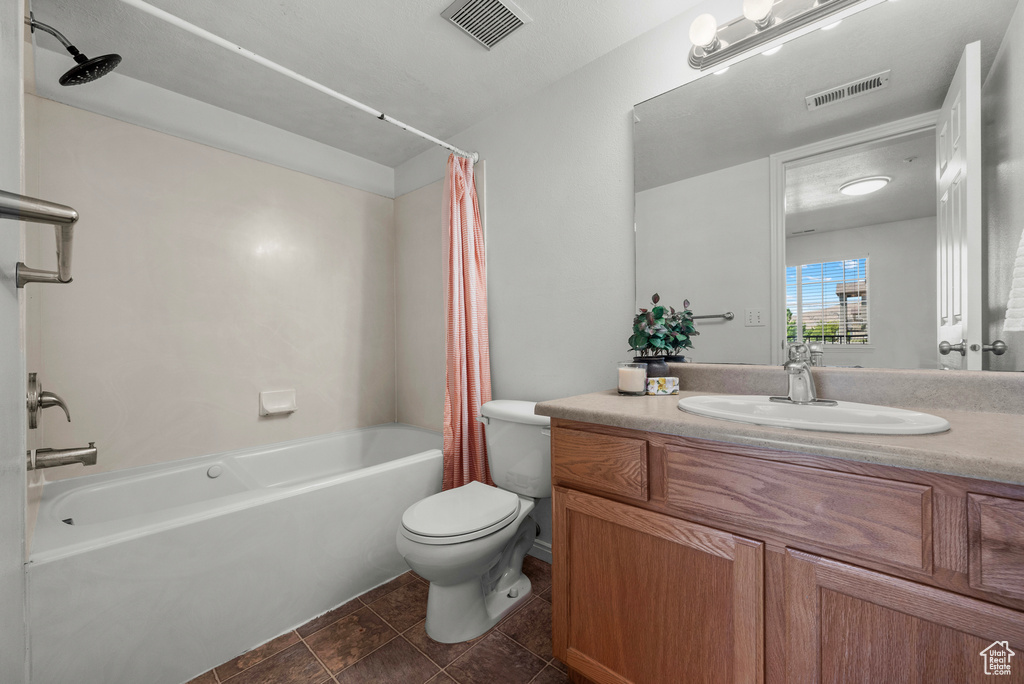 Bathroom featuring shower / tub combo, vanity, and tile patterned floors