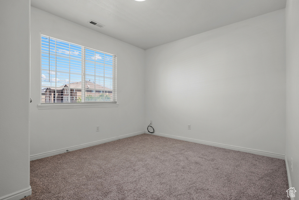 Unfurnished room with carpet and baseboards
