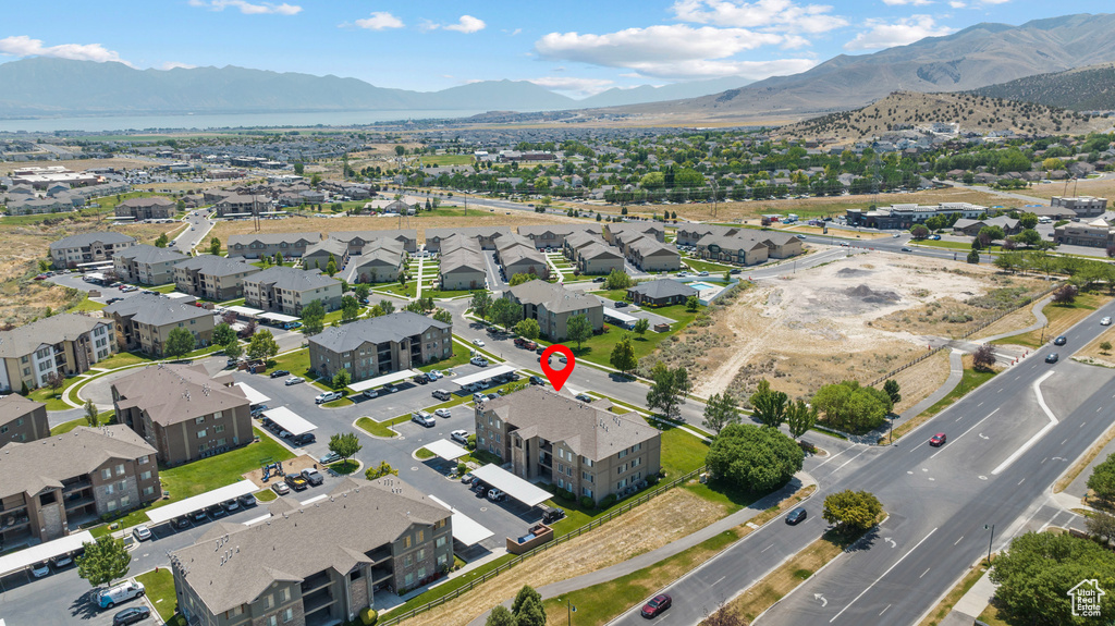 Aerial overview of property's location with a mountainous background and nearby suburban area