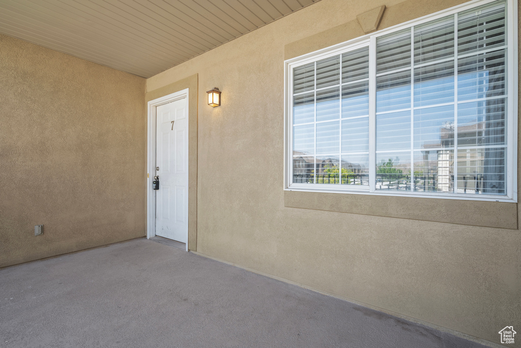 Doorway to property with stucco siding and a patio