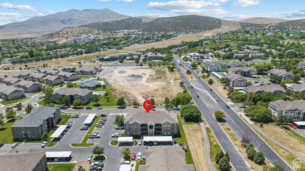 Aerial overview of property's location with nearby suburban area and a mountainous background