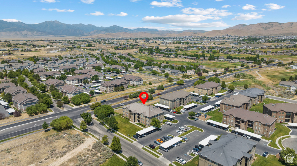 Aerial overview of property's location with a mountain backdrop and nearby suburban area