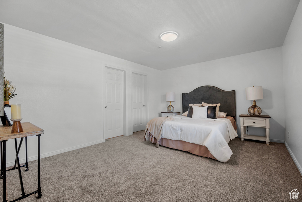 Carpeted bedroom with baseboards