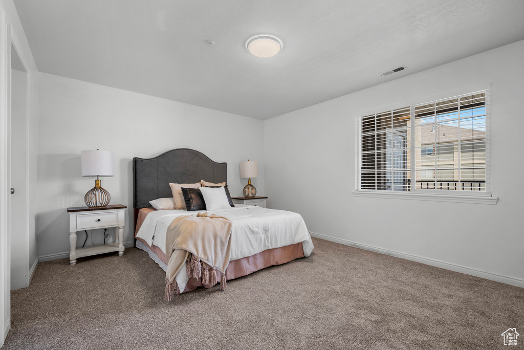 Carpeted bedroom with baseboards