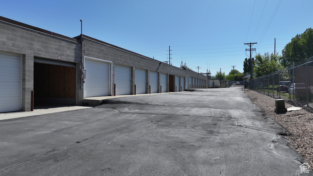View of asphalt alley with community garages