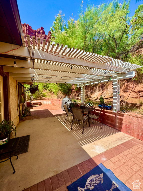 View of patio featuring a pergola and outdoor dining space