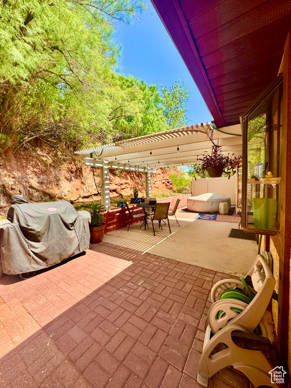 View of patio featuring a pergola, outdoor dining space, and grilling area