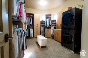 Laundry area featuring stacked washer and clothes dryer