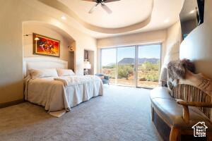 Bedroom with access to outside, carpet floors, and ceiling fan