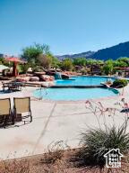 Community pool with a mountain view and a patio