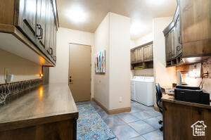 Kitchen featuring washer and clothes dryer and stainless steel countertops