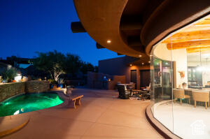Pool at night with a patio