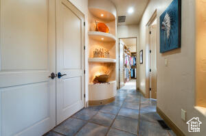 Hallway featuring baseboards and recessed lighting