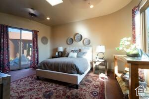 Bedroom with access to exterior, multiple windows, and recessed lighting