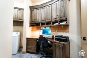 Home office featuring built in study area and washer / clothes dryer