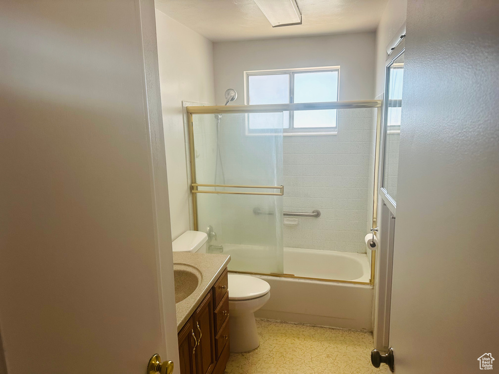 Bathroom with vanity, combined bath / shower with glass door, and tile patterned floors
