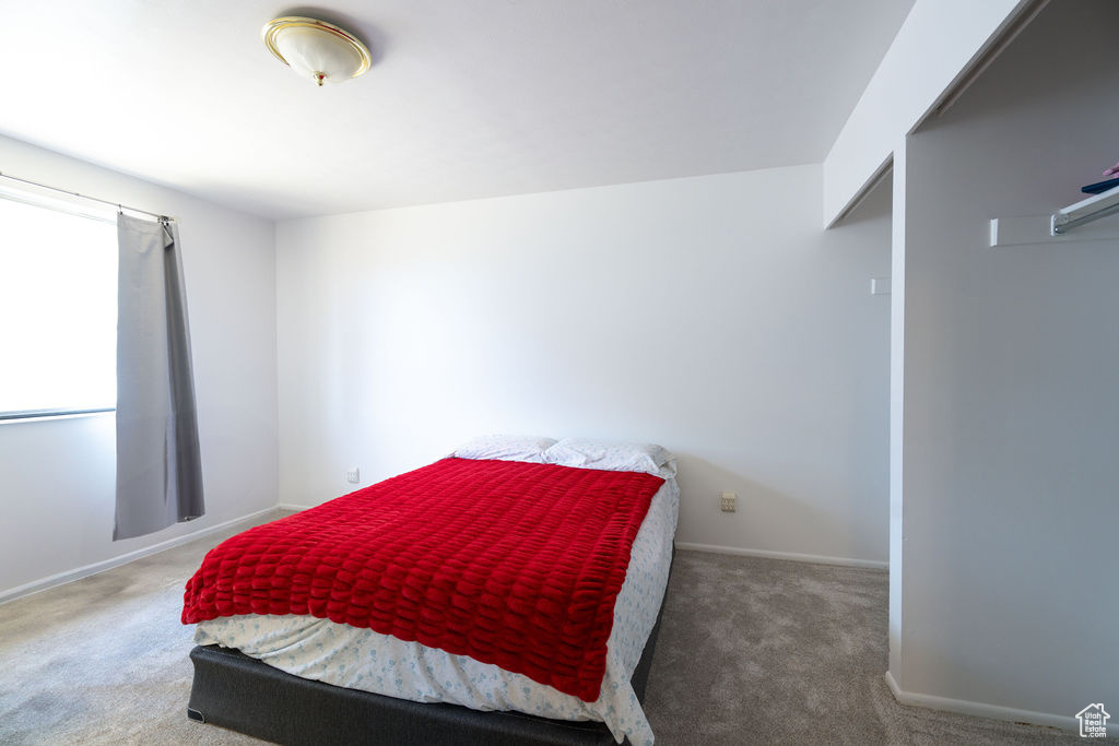 Carpeted bedroom featuring baseboards