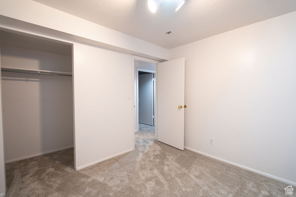 Unfurnished bedroom with carpet floors and a closet