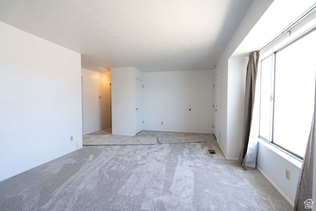 Spare room featuring light colored carpet
