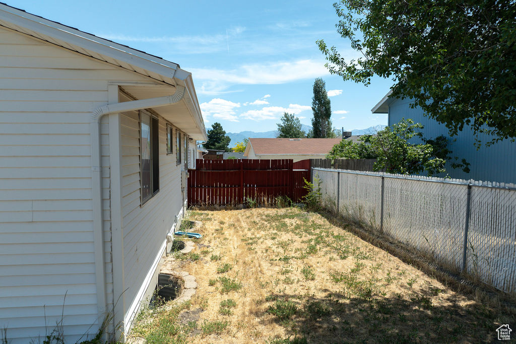 Fenced backyard with a mountain view