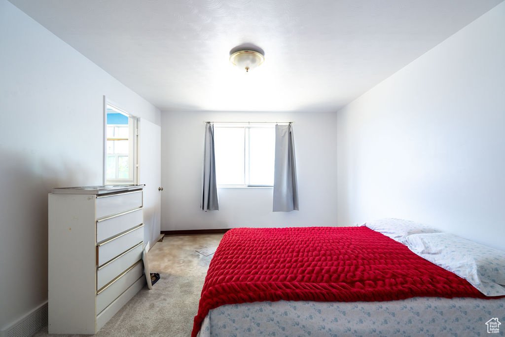 Bedroom featuring light colored carpet