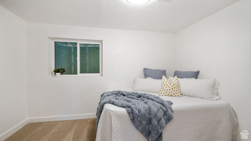Carpeted bedroom featuring baseboards