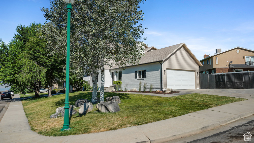 View of front of house with concrete driveway, brick siding, and a garage