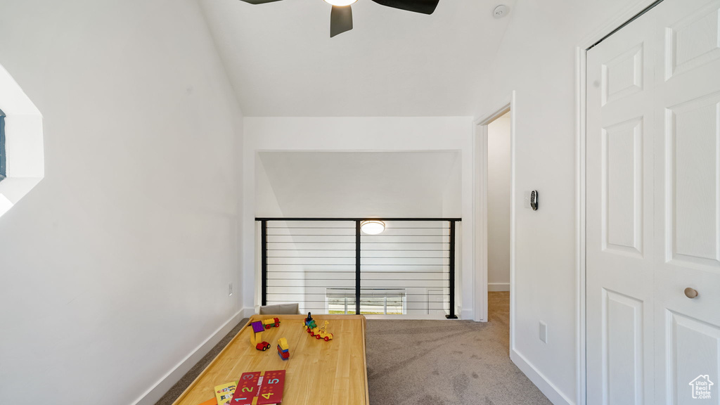 Recreation room featuring ceiling fan and carpet flooring