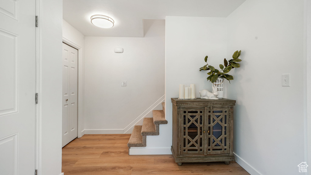 Stairs featuring wood finished floors