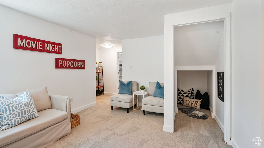 Sitting room featuring light colored carpet