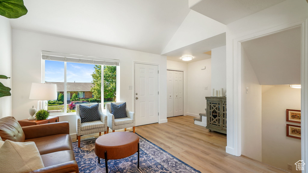 Living area featuring light wood-type flooring and lofted ceiling