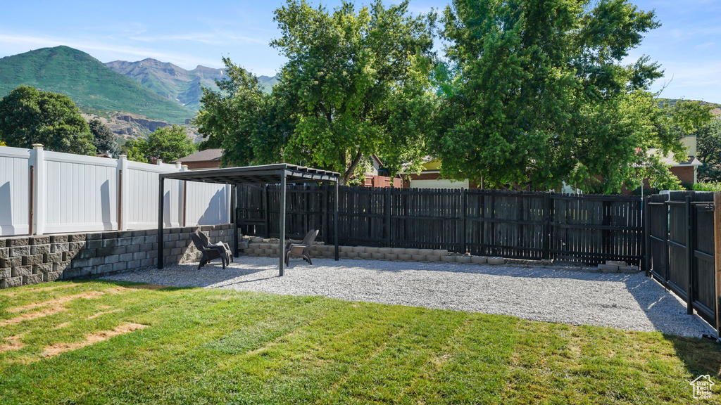 Fenced backyard featuring a mountain view
