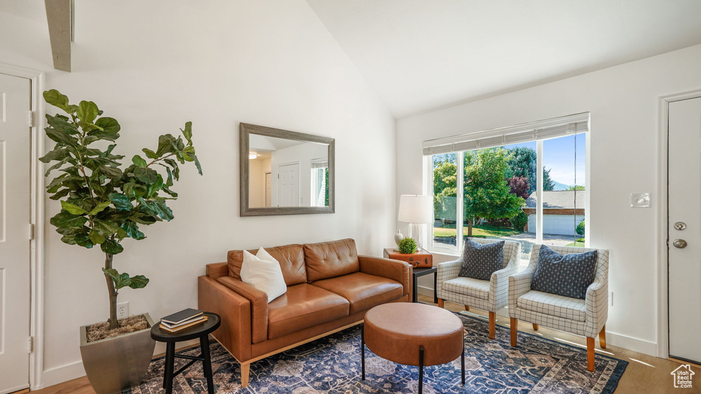 Living area with high vaulted ceiling and wood finished floors
