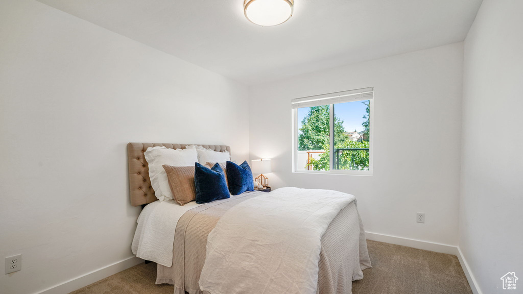 Carpeted bedroom featuring baseboards